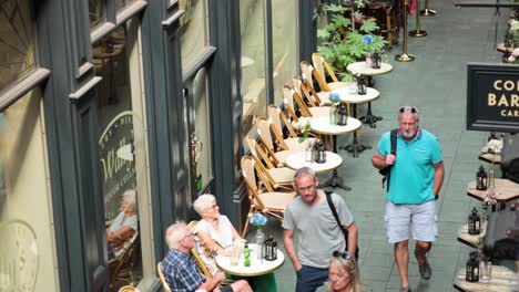 people walking past a coffee bar