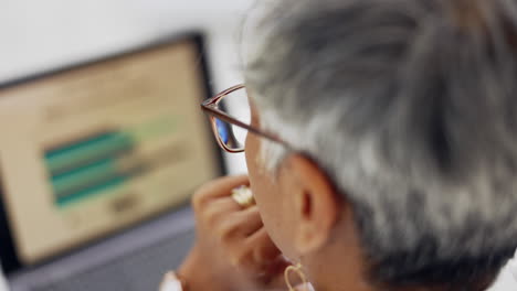 back of woman, head and working on laptop