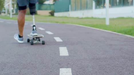 close-up of man with prosthetic leg riding on skateboard