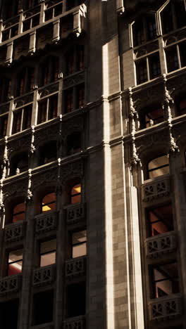 a close-up of a tall building with many windows and a brick facade