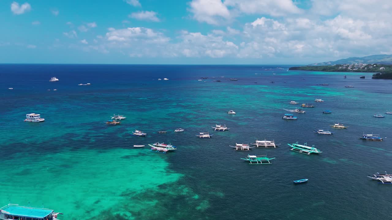 Stunning aerial of Boracay’s turquoise waters with boats over vibrant coral reefs. Perfect for travel, tourism, tropical lifestyle, and ocean adventure projects