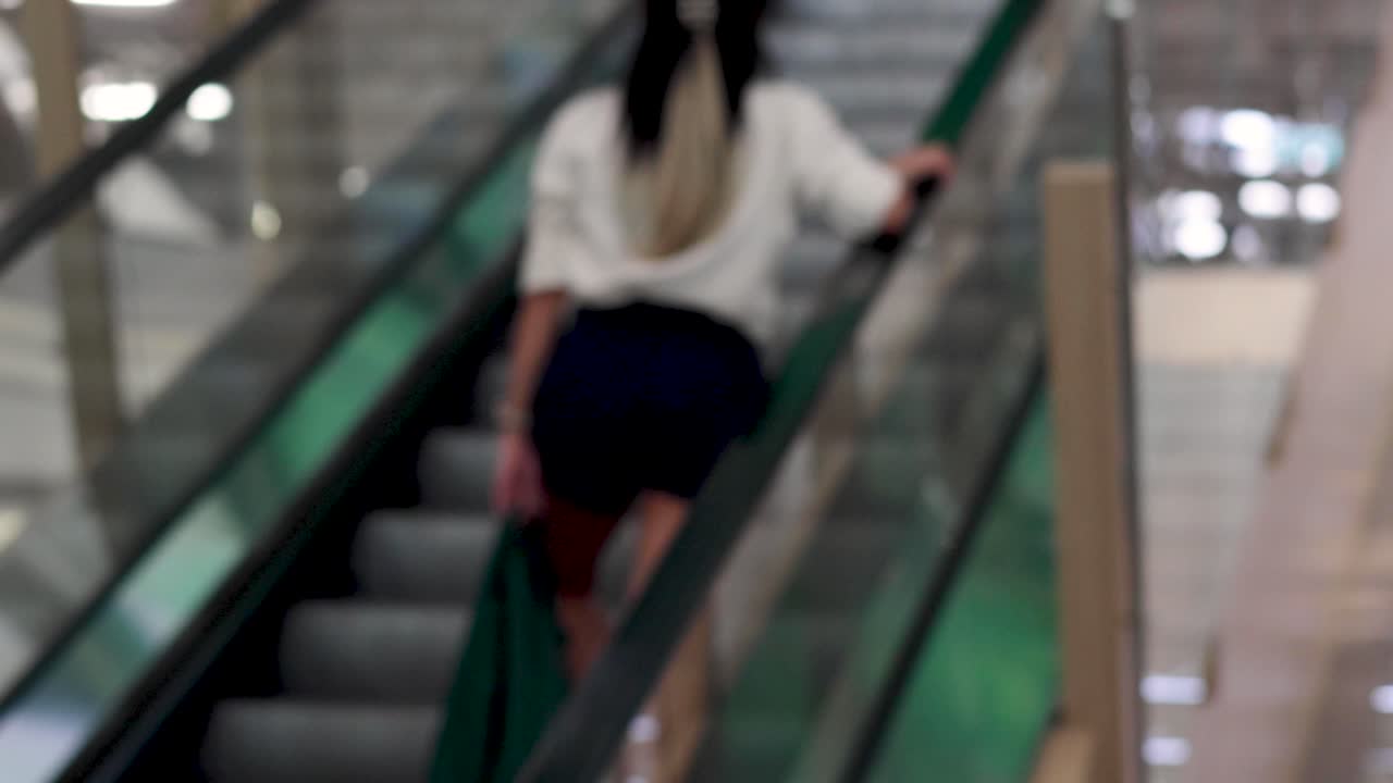 Person ascending on an indoor escalator