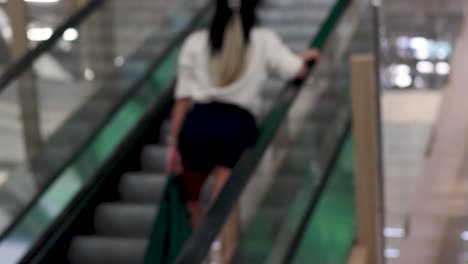 person ascending on an indoor escalator