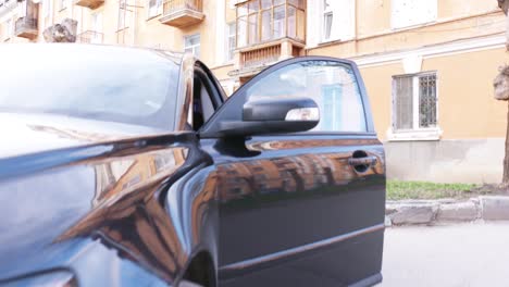 woman getting out of a car in a city