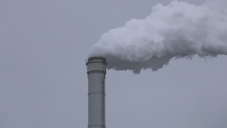 grey smoke coming out from a chimney