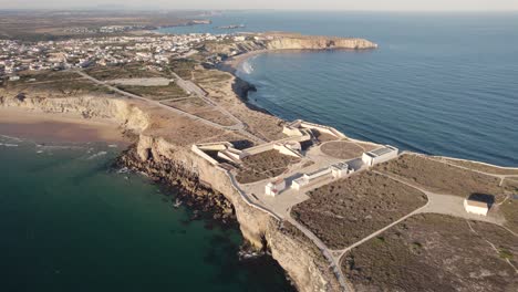 aerial perspective of the colour dynamic ocean with fortaleza de sagres fortress in the centre