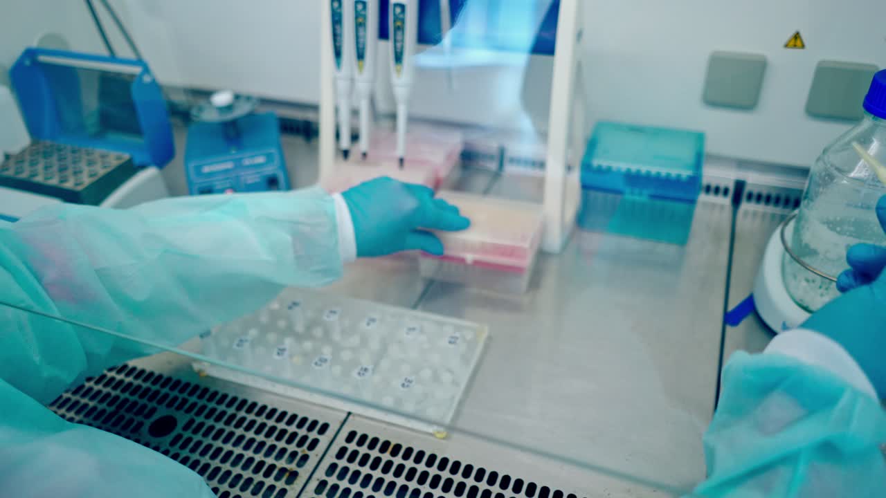 Medical equipment blood test in laboratory. Female technician analyzing blood sample in medical laboratory