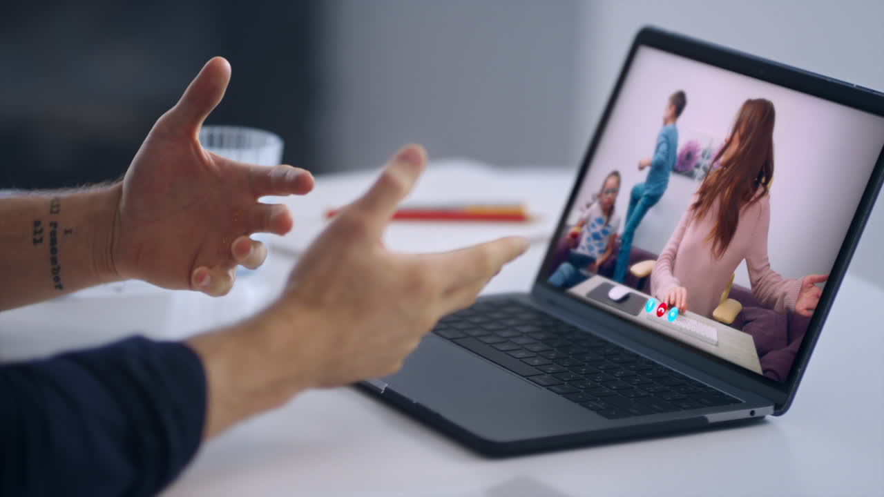 Office manager talking laptop screen at family video chat shoulder view close up