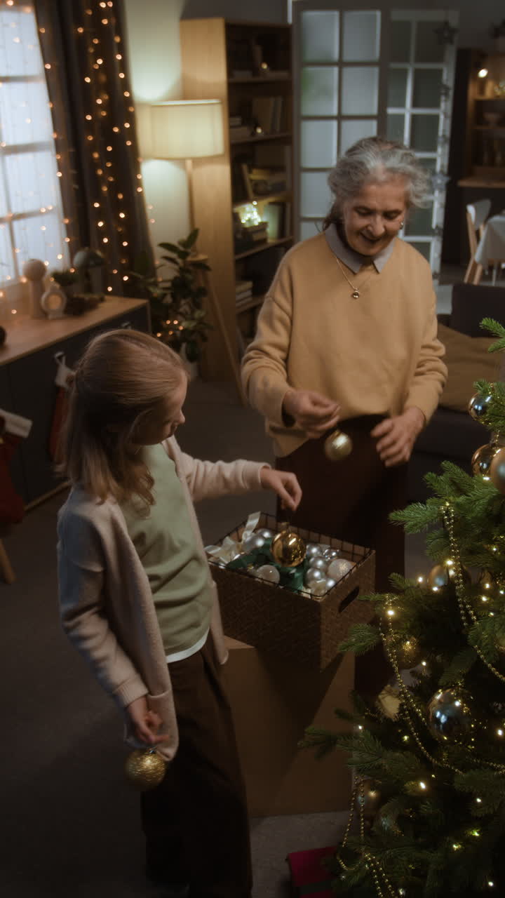 Grandmother and Granddaughter Decorating Christmas Tree