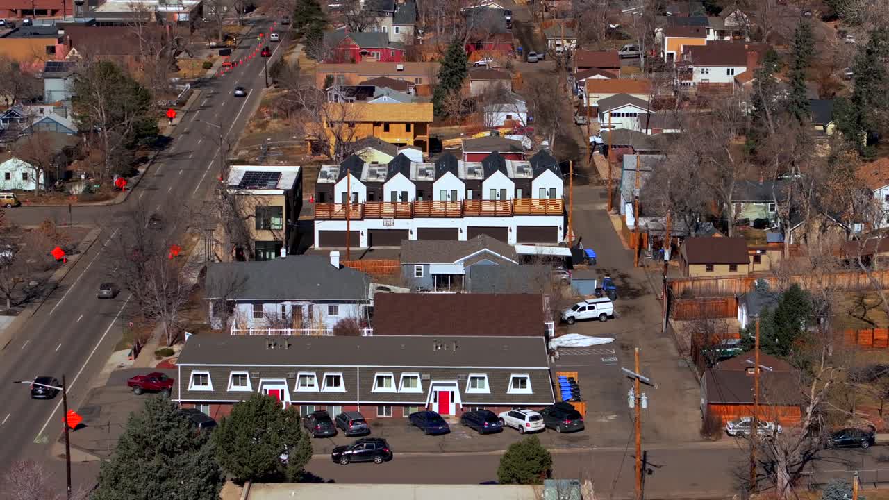 Historic Golden Colorado aerial drone neighborhood homes condominiums buildings Colorado School of Mines cars streets trees telephone lines North Table Mountain Postal service truckstatic shot