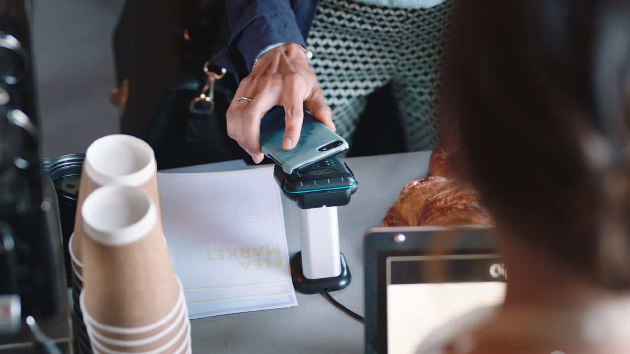 customer paying using smartphone contactless payment in cafe enjoying service spending money at restaurant