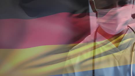 Animation-of-flag-of-germany-with-masked-male-doctor-smiling