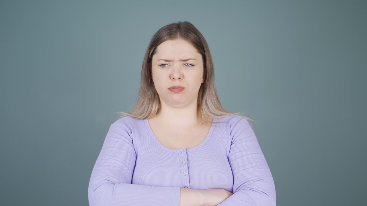 Young woman looking depressed at camera.