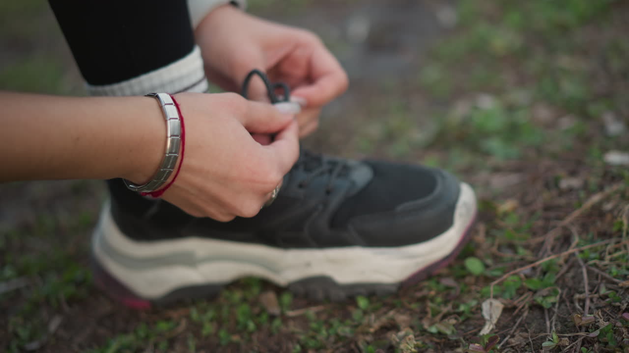 Tying Shoes Before Exercise, Focusing On Knotting Technique For Running, Practicing Lace Tying For Smooth Jogging Experience, Ensuring Proper Shoe Lace Knotting To Prepare For Athletic Activity