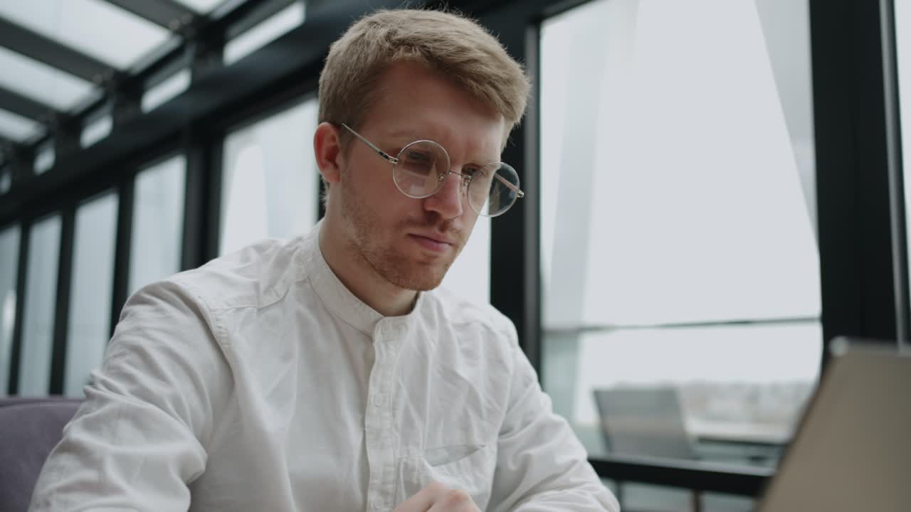 espacio de coworking moderno para freelance y trabajador remoto, hombre adulto está trabajando con computadora portátil en el área de la oficina o cafetería