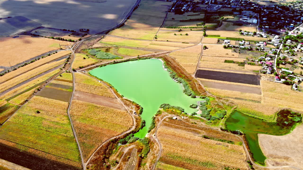 Aerial drone view of a village and lake from north part of Moldova. Sunny day