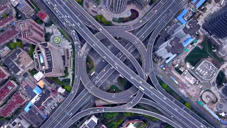 time lapse of aerial view of highway junctions with roundabout. bridge roads shape circle in structure of architecture and transportation concept. top view. urban city, shanghai downtown, china.