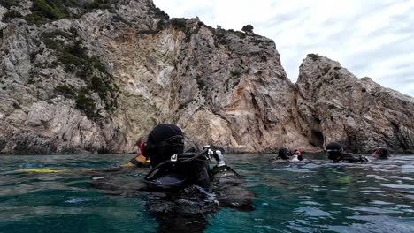 group of people with snorkeling equipment on prepare to dive in greece