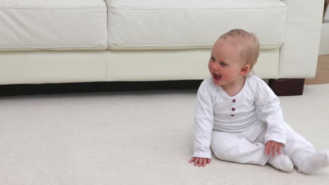 baby sitting in front of the sofa