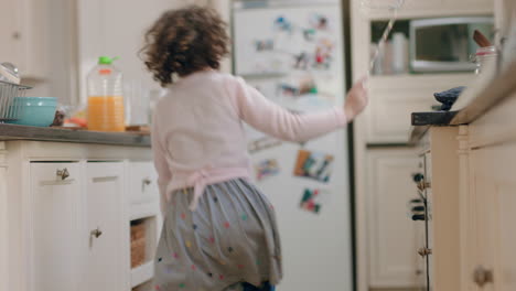 happy-little-girl-dancing-in-kitchen-having-fun-doing-funny-dance-moves-enjoying-weekend-at-home