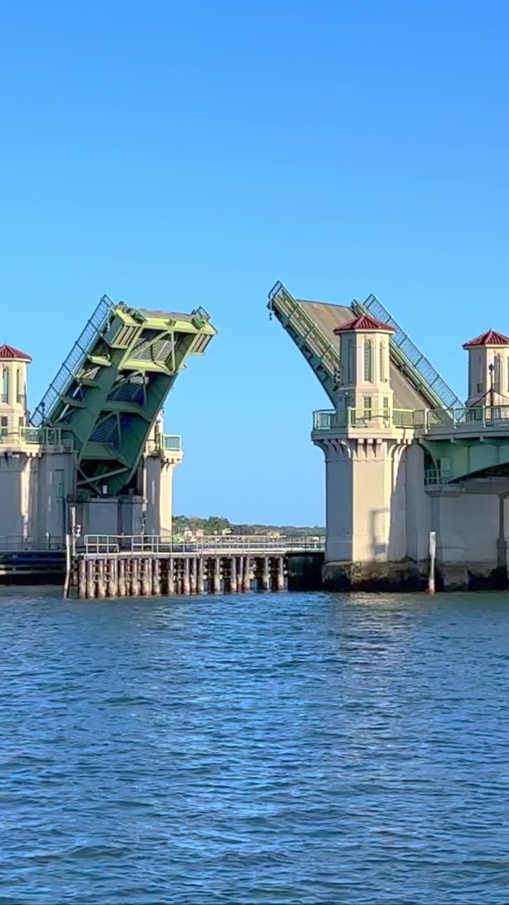 Intercoastal ocean drawbridge closing after sailboat goes under, sunny blue sky
