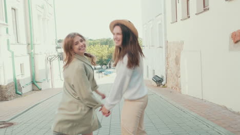 two joyful women having fun on a city street