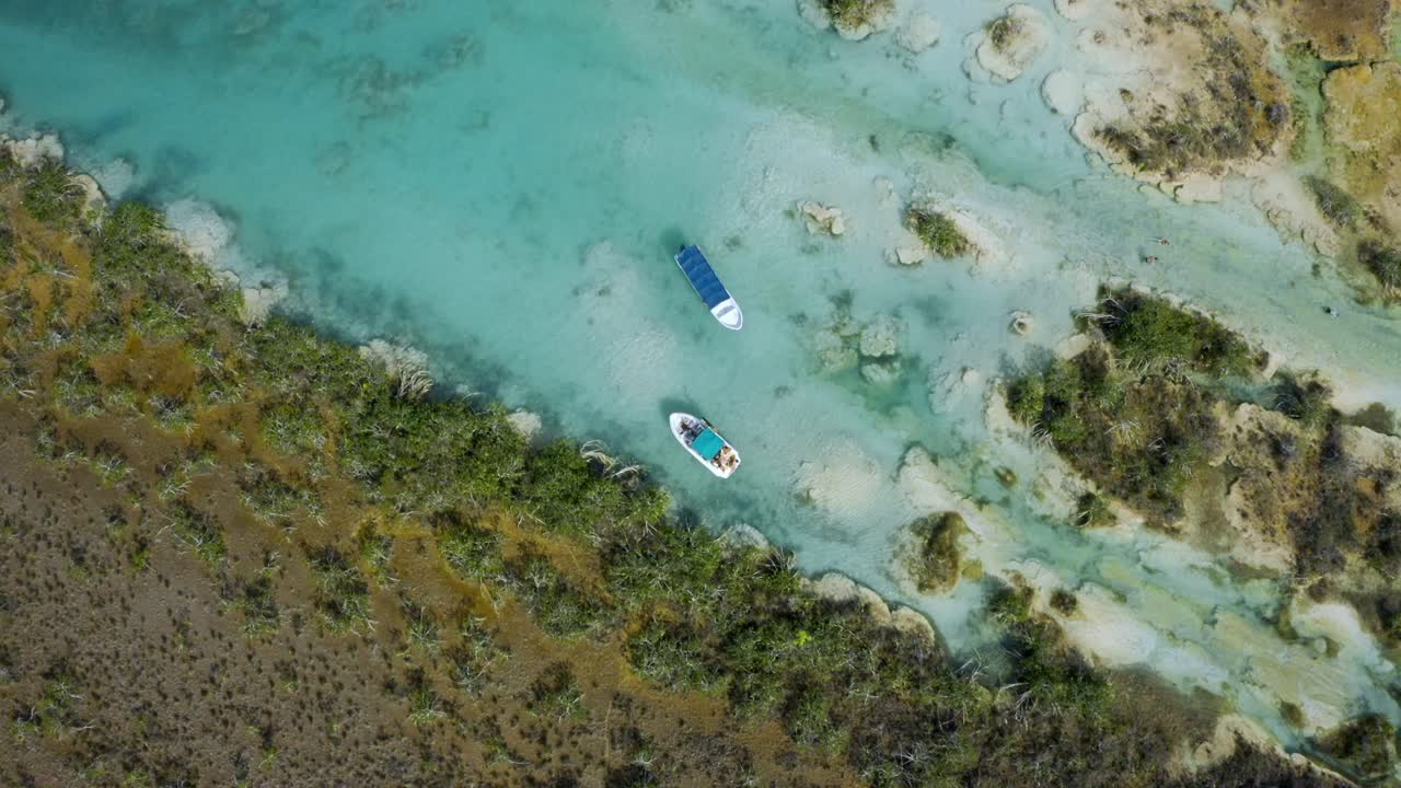 A high-angle drone shot capturing the famous Bacalar Lagoon in Quintana Roo, México