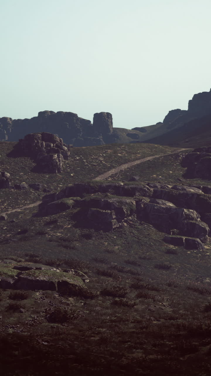 Rocky landscape with winding path under hazy sunlight in the afternoon