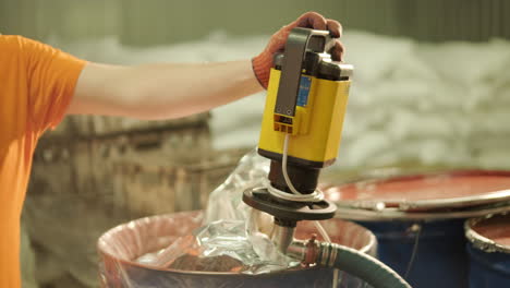 industrial worker operating a mixing machine
