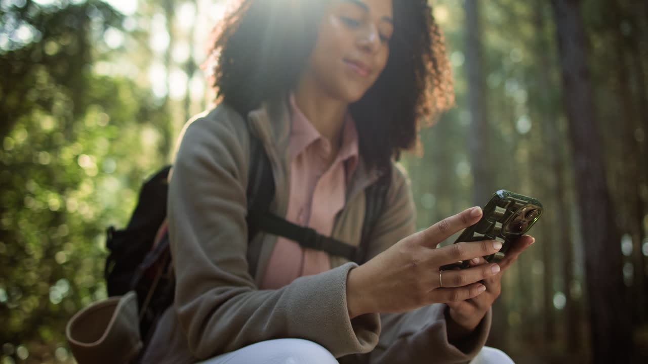 Woman using mobile phone in the forest