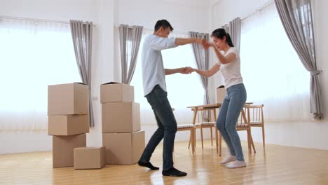 happy couple having fun at new home