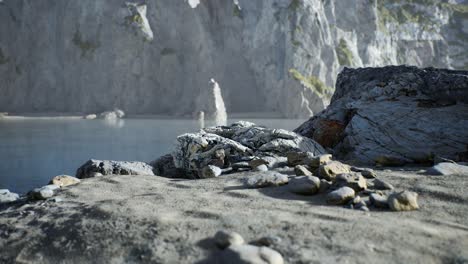 sand beach among rocks at atlantic ocean coast in portugal