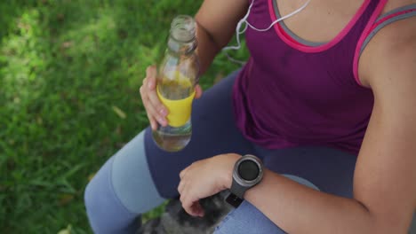 caucasian woman drinking water in a park