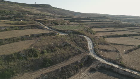 Aerial-Footage-of-a-runner,-male-jogging-in-Gozo