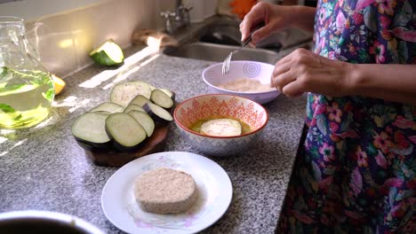 coating sliced eggplant with bread crumbs, dip into seasoned egg, then coat again with bread crumbs