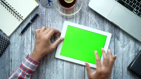 flat composition of young man suing digital tablet on office desk