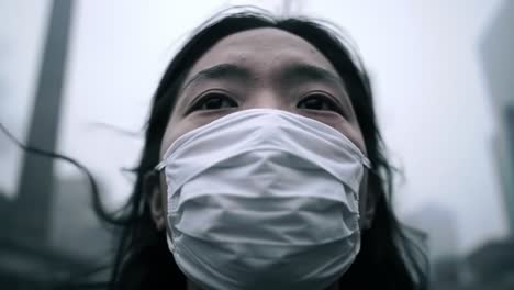 a close-up reflection of a young individual wearing a face mask against a hazy skyline, capturing the essence of urban life in a polluted environment