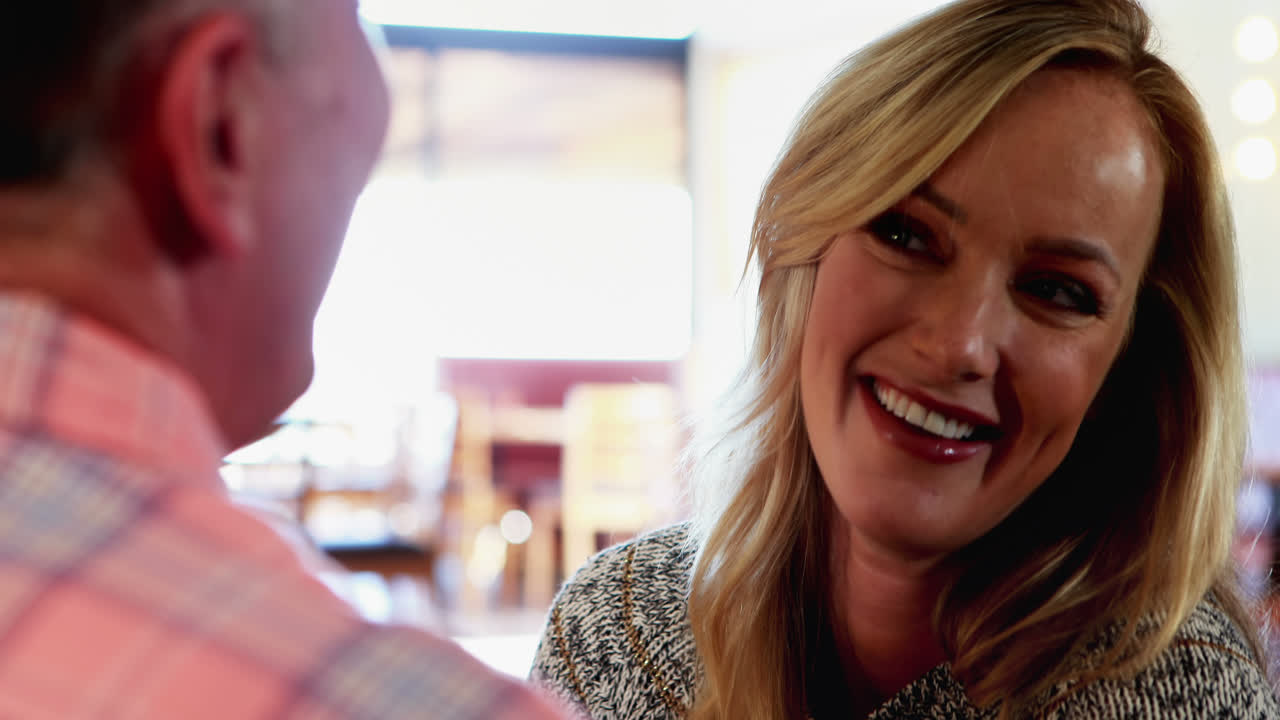 Couple interacting with each other in bar 4k