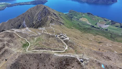 Roys-Peak-mountain-summit,-aerial-reveal-horizon