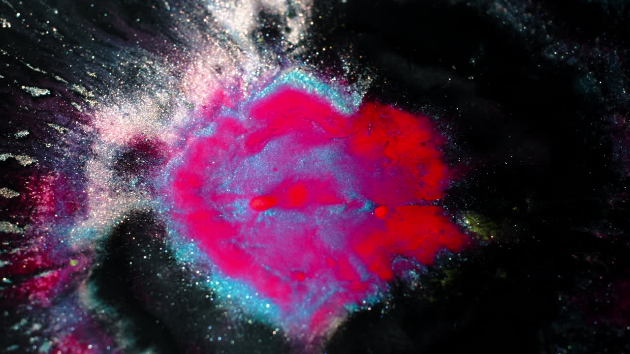 Close-up of colorful substances mixing in vibrant patterns and textures