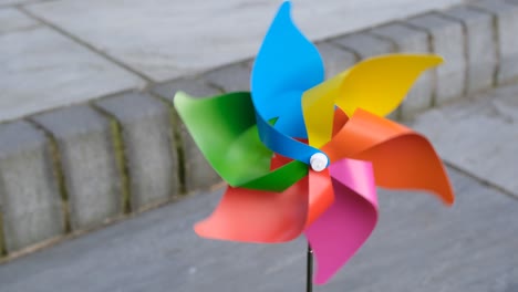 single multi coloured rainbow pinwheel spinning very fast