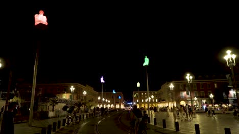 night view of a city square with illuminated sculptures