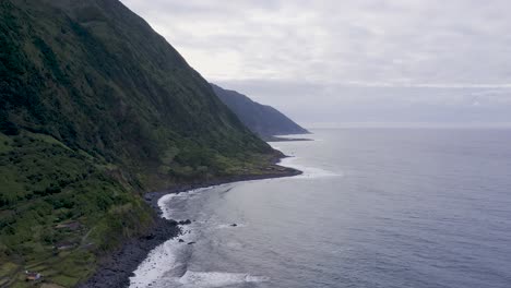 drone view of island coastal, lush green cliffs landscape, fajã de santo cristo, são jorge island, the azores, portugal