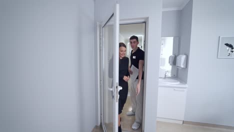 pretty woman coming into dentist office. young lady visits stomatologist. modern light dental cabinet in private clinic.