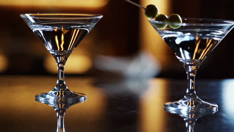 two martini cocktails on a bar