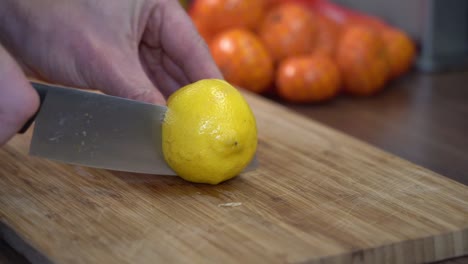 Cutting-lemon,-two-pieces-fall-down-rolling-in-slow-motion