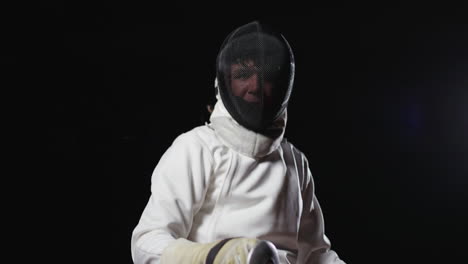 a fencer in a white uniform holding a sword