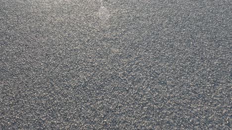 close-up view of moving gravel road