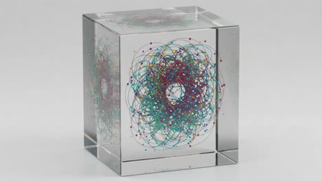 a captivating display of colorful patterns and intricate designs within a transparent cube - an artistic representation of geometry and visual motion