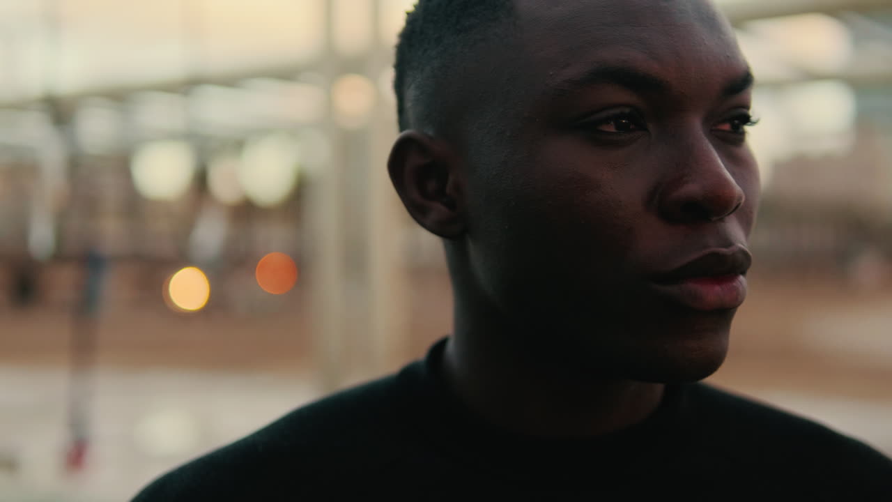 Close Up Portrait of a Thoughtful Young Black Man Looking Around
